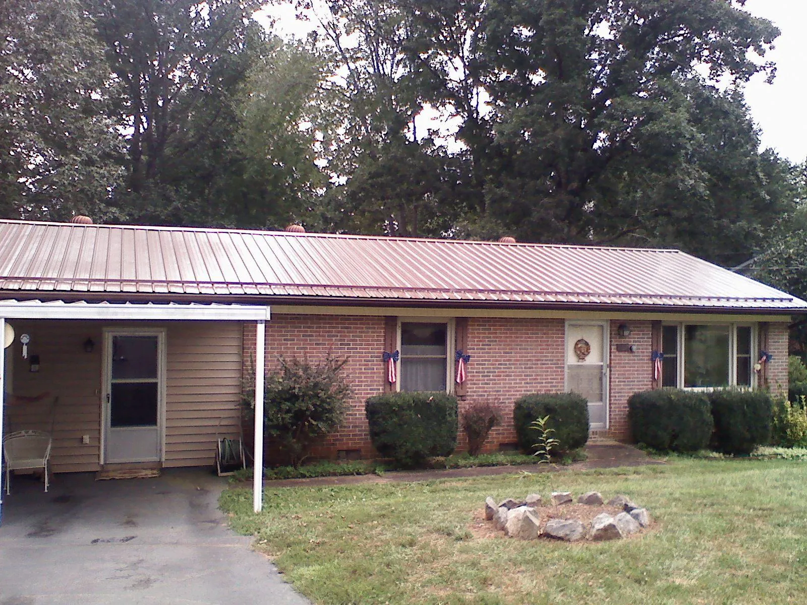 Bronze metal roof and carport on a brick ranch home — Roof Repair work by our crew in Shadyside