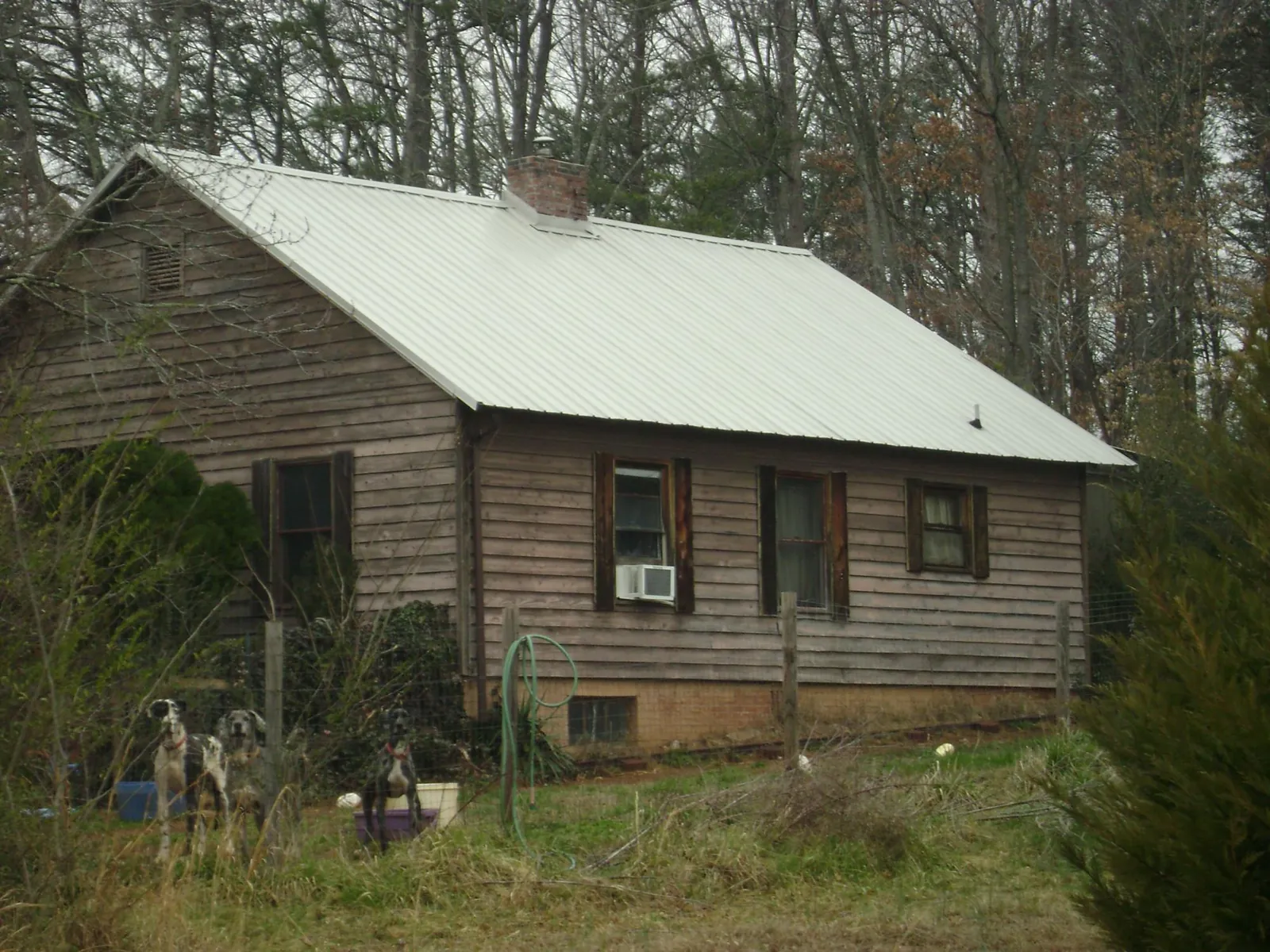 White metal roof on an old wood sided farmhouse, from a Metal Roof Installation job in Shadyside
